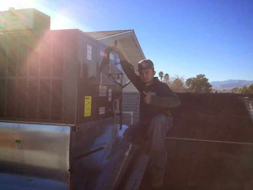 HVAC technician performing AC Tune-Up on a rooftop unit in Tredyffrin